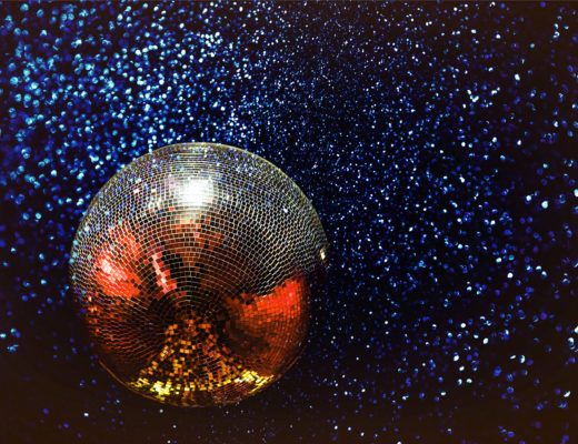 A mirrorball suspended against stars.